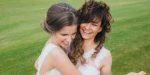 Two beautiful brides dancing on the green field of the golf club