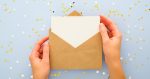 white invitation in a brown envelope