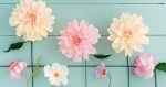 Pink and yellow paper blooms, all ready to put on a your DIY paper flower wedding arch
