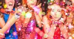 Young friends having party throwing confetti - Young people celebrating on weekend night - Entertainment, fun, new year's eve, nightlife, holidays, concept - Focus on red hair girl hands