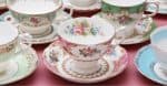 Vintage china tea cups on a dusty pink background