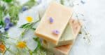 Natural handmade soap bars with organic medicinal plants and flowers.Homemade beauty products with natural essential oils from plants and flowers, top view closeup phot