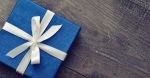 Blue elegant gift box on a wooden background