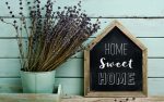 home sweet home written in a DIY signage beside a pot with dry plants as a housewarming gift for young couple