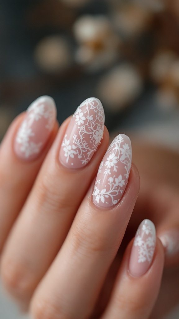 Close-up of bridal nails featuring delicate white lace patterns on a soft pink base.