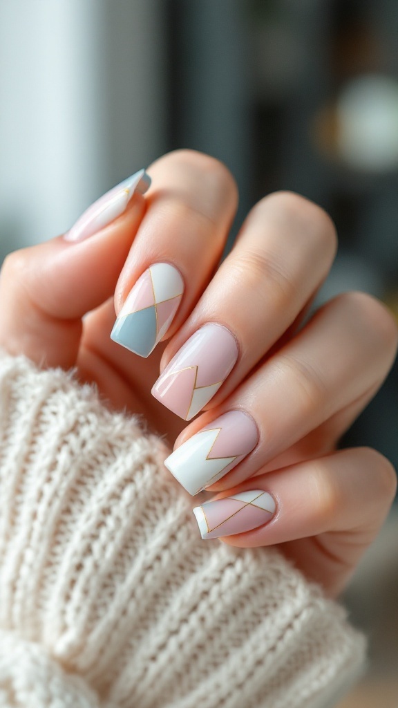 Close-up of square wedding nails featuring geometric patterns in pastel colors with gold accents.