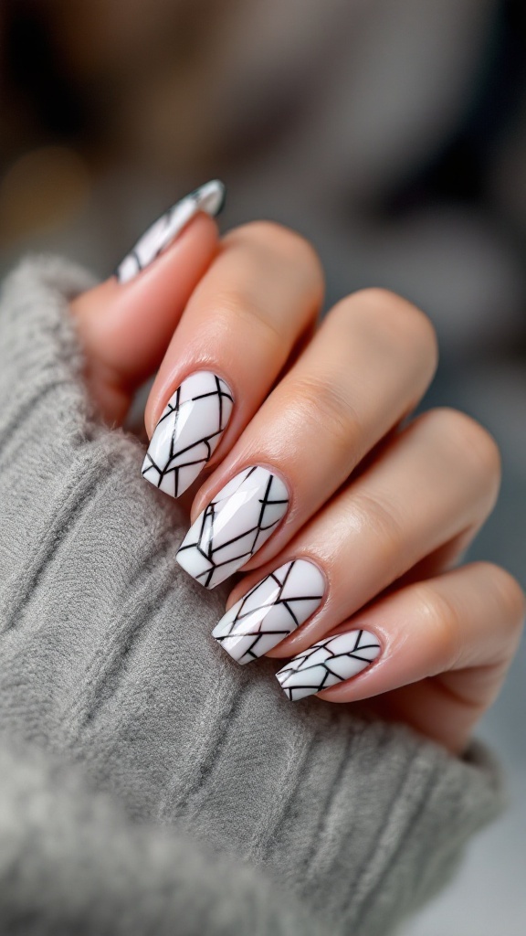 Close-up of beautifully manicured wedding nails with a white base and black geometric patterns.