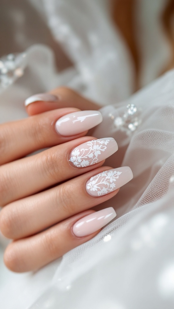 Nude gel nails with white lace detailing against a soft fabric background
