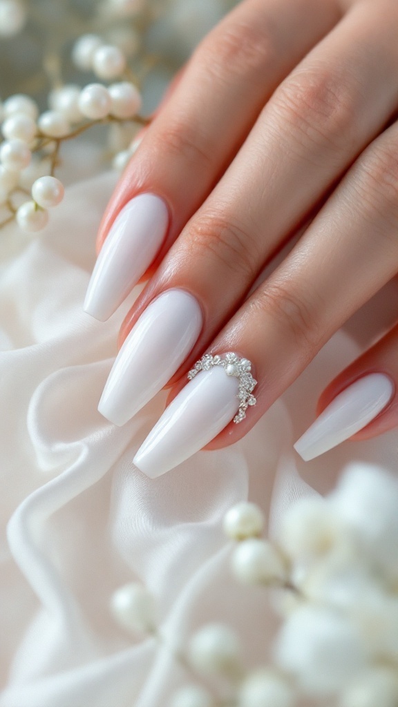 Soft white bridal nails with pearl and diamond embellishments