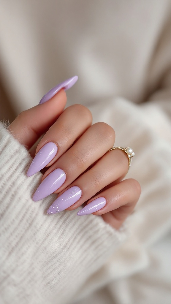 Lavender stiletto nails with pearl details, showcasing elegant nail art against a soft, cozy background.