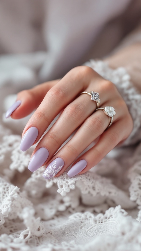 Close-up of a hand with matte lavender nails featuring white floral designs, adorned with rings, resting on lace fabric.