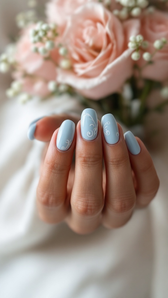 Light blue wedding nails with artistic swirls, set against a backdrop of soft pink roses.