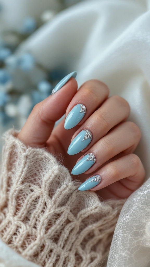A close-up of light blue wedding nails with rhinestone embellishments, showcasing elegant finger styling
