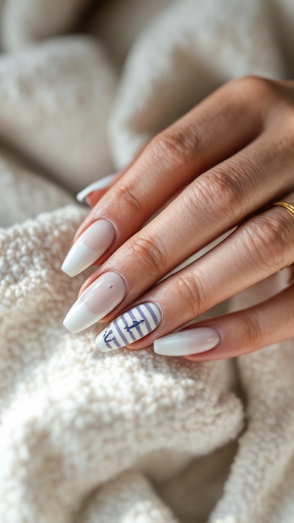 Nail design featuring nautical stripes and anchor accents on a hand resting on a textured fabric