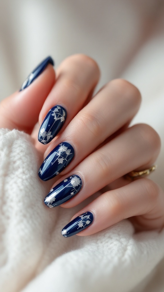 Close-up of navy blue wedding nails with silver geometric patterns.