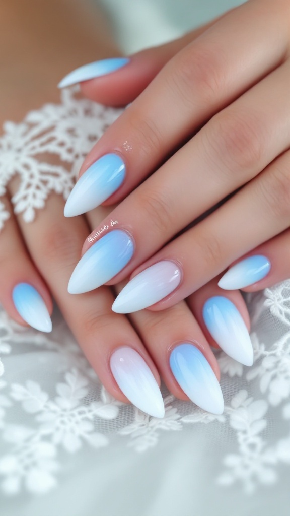 A hand with pastel light blue wedding nails featuring pearls, surrounded by white flowers.