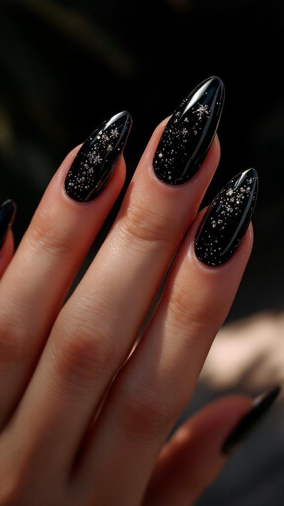 A close-up of black stiletto nails with glitter accents, showcasing a stylish and modern nail design.