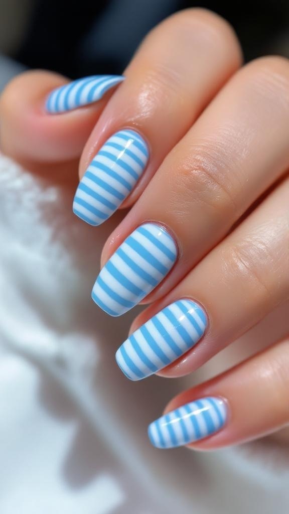 Close-up of blue and white striped acrylic nails with gold rings on fingers