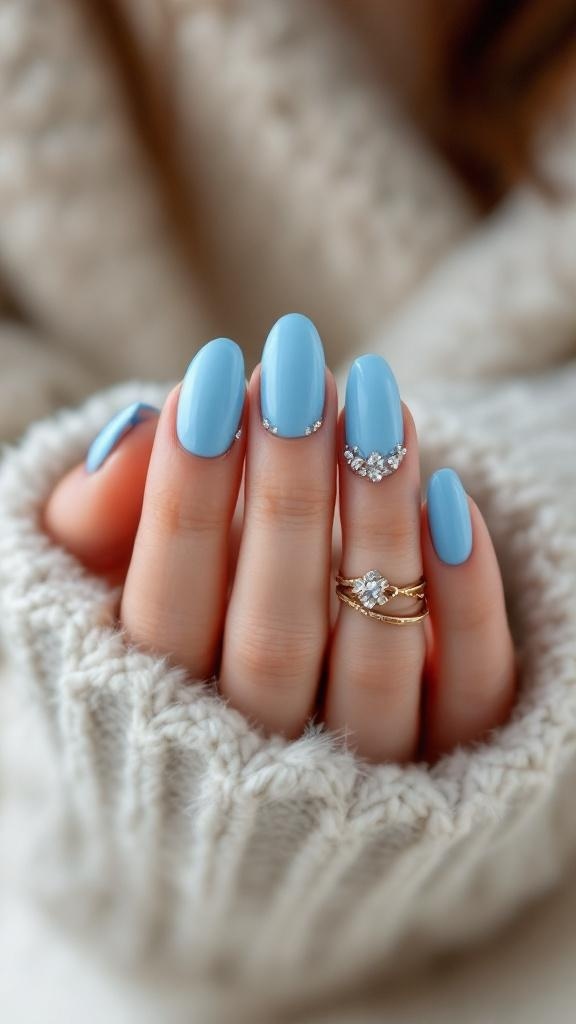 Bright sky blue acrylic nails with rhinestones, showcasing a polished and stylish look.