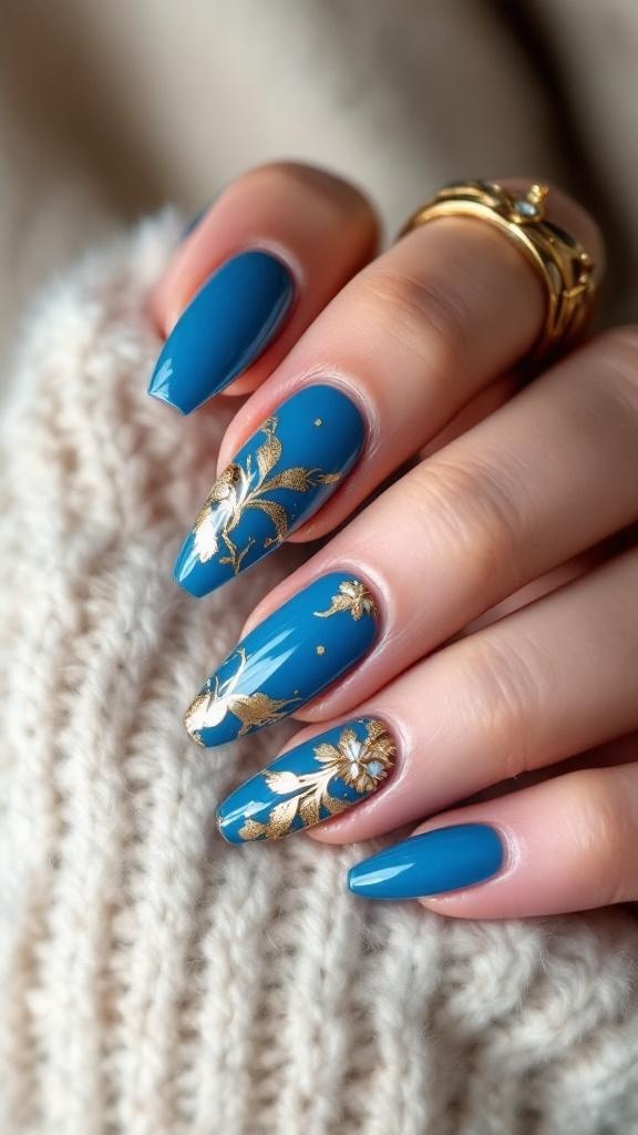 Cerulean blue acrylic nails with gold foil designs