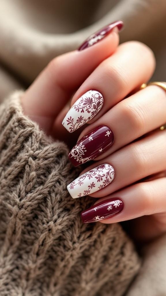 Close-up of cherry wine colored nails with white floral stamping designs