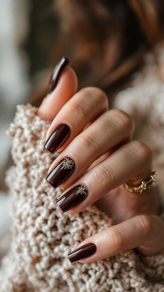 Close-up of dark brown nails with sparkly designs