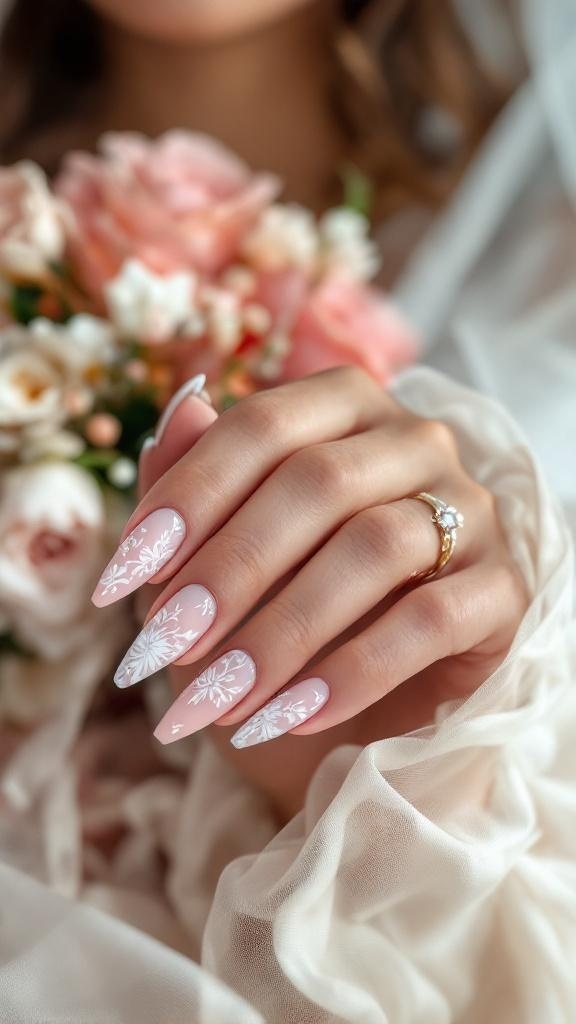 Elegant bridal nails with floral designs, showcasing a bride's hand holding a bouquet.