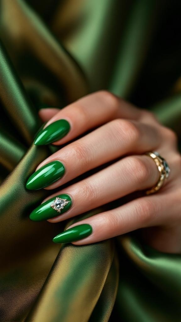 A close-up of hands with green chrome nails, wearing a delicate gold ring, resting on a soft beige fabric.