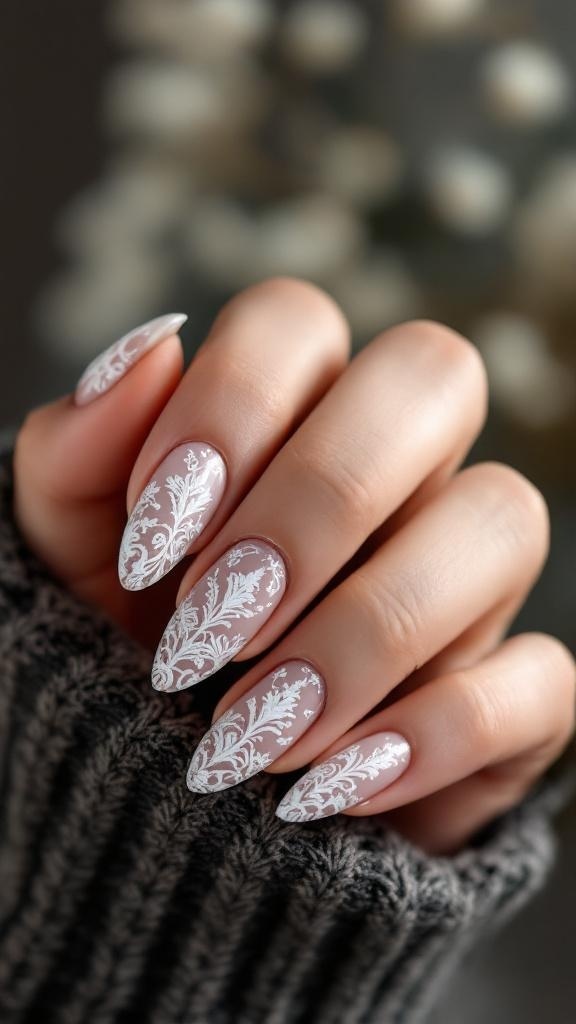 Close-up of hands with intricate lace almond nail design on a cozy sweater background.