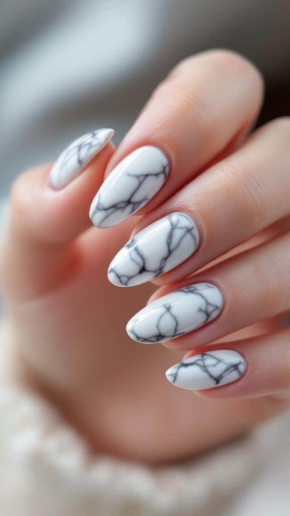 Close-up of hands with almond-shaped nails featuring a marble effect design.