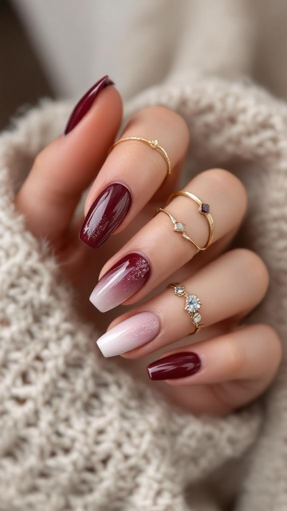 Nails featuring an ombre cherry wine effect with gold rings