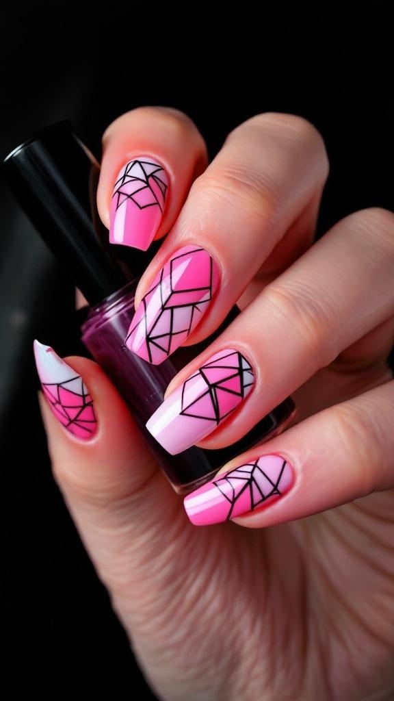 Close-up of hands with pink cat eye nails featuring black geometric patterns, resting on a black leather surface.