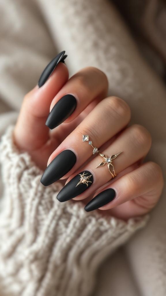 A close-up of black stiletto nails with a matte finish, featuring metallic accents and rings.