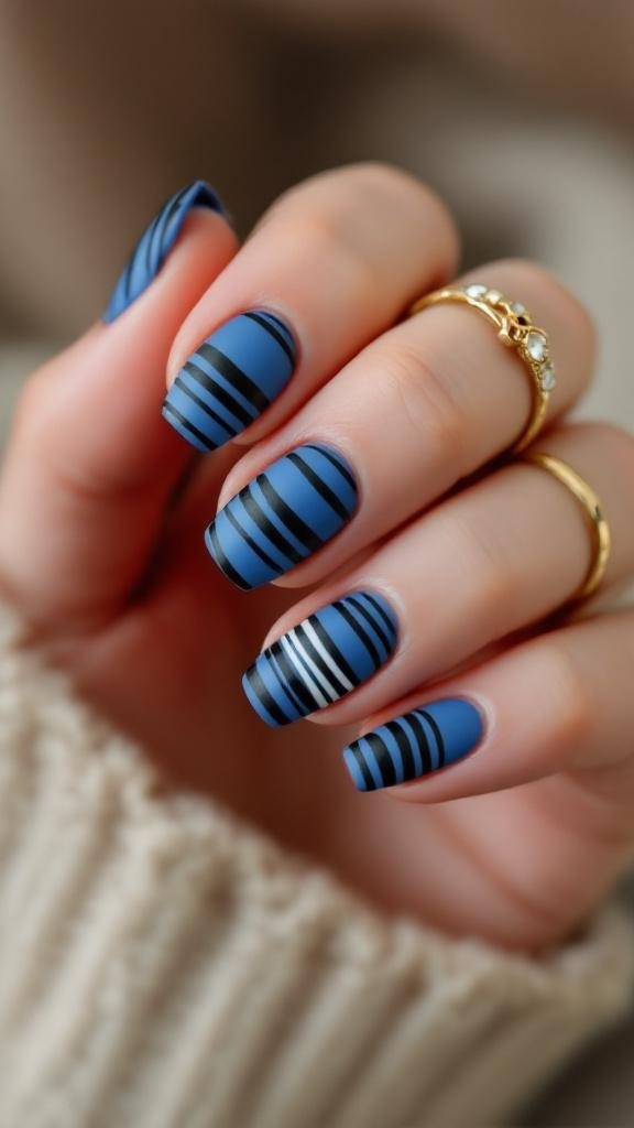 Nails painted with blue and black stripes, featuring a matte finish.